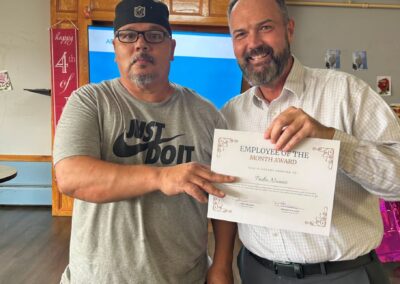 Westwood Administrator Jon awarding Maintenance Manager Pedro a certificate for Employee of the Month