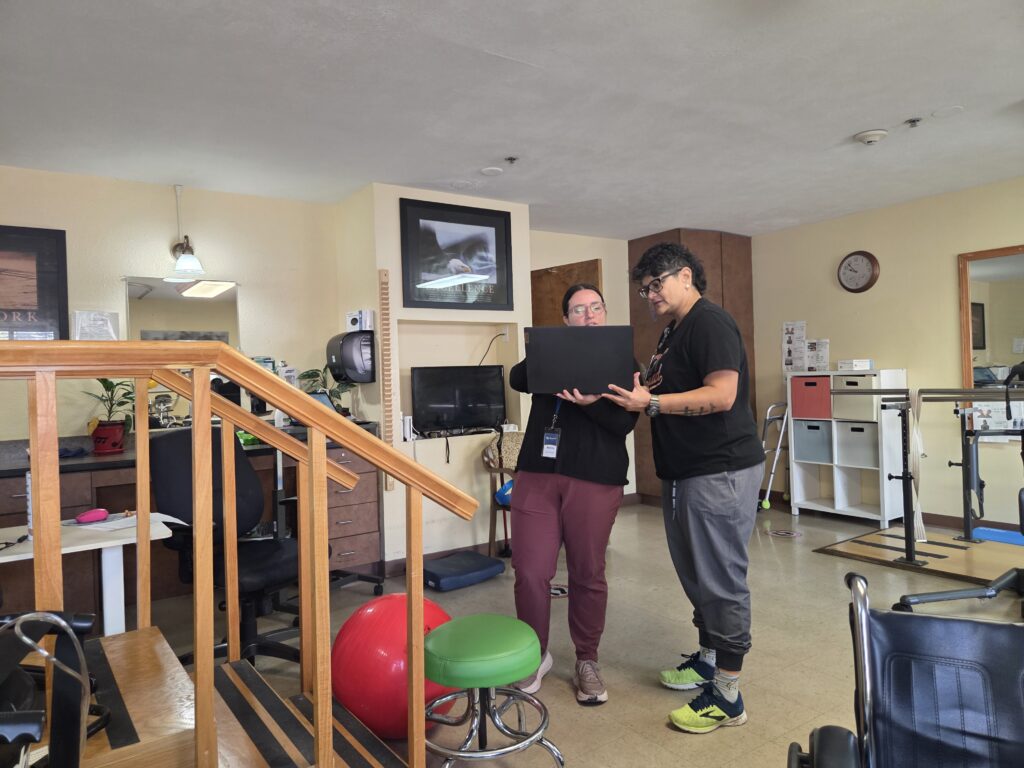 Malissa Sanchez meeting with a therapy employee to discuss plans for a patient