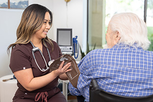 A nurse checking the blood pressure of an elderly resident at Sunnyvale Gardens