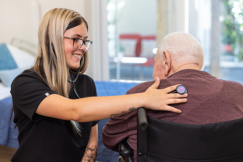 Nurse listening to lungs of a patient