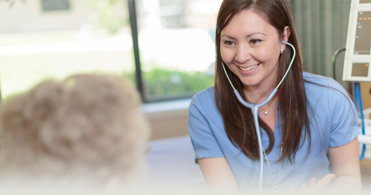 Smiling nurse comforting smiling patient