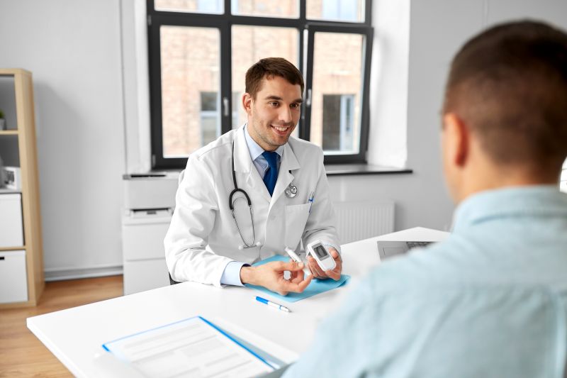 Doctor discussing diabetes testing tools with patient