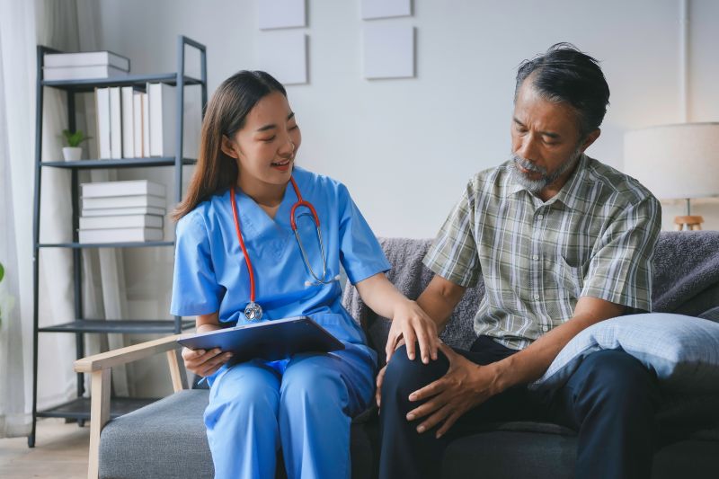Nurse discussing knee pain with patient