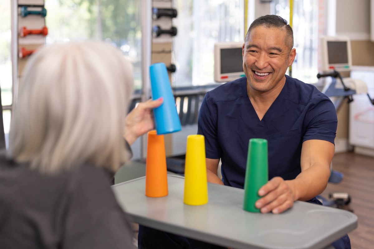 Smiling Occupational Therapist working with patient